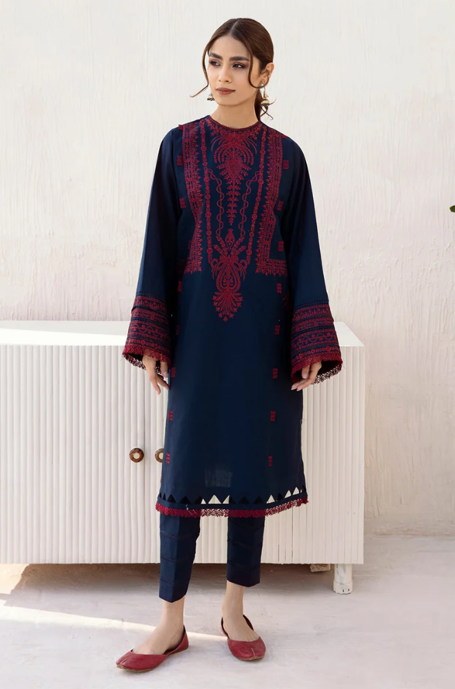 A model displays a navy blue kurta suit featuring exquisite embroidery, representing a blend of style and cultural heritage.