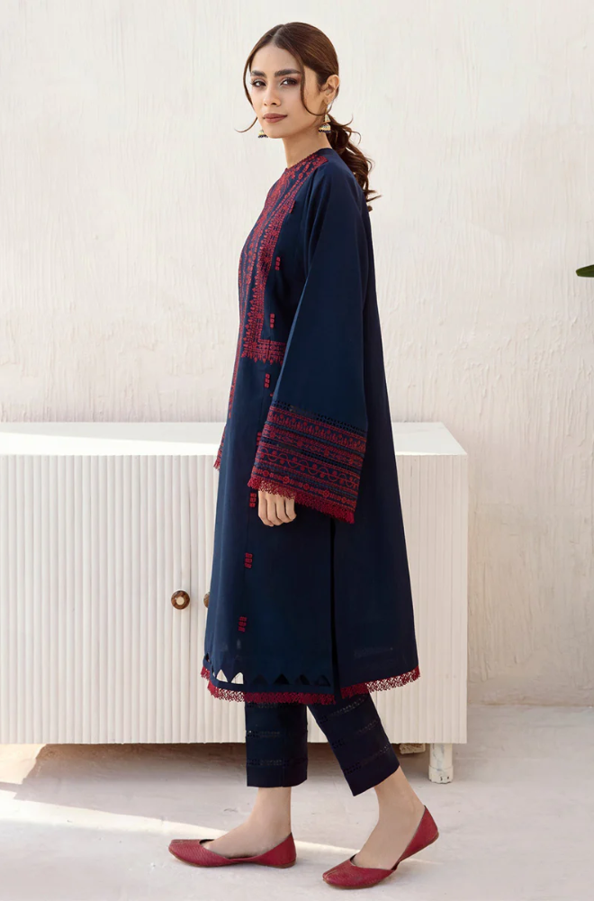  A model wearing a navy blue kurta suit adorned with intricate red embroidery, showcasing traditional elegance and style.
