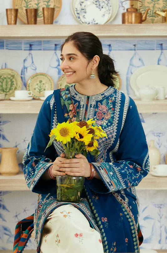 A woman relaxes on a chair, adorned with a backdrop of blooming flowers, exuding tranquility and beauty.