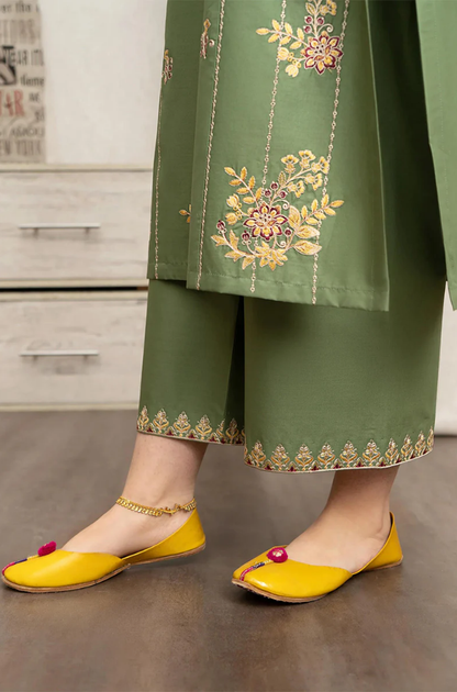  green embroidered kurta paired with stylish yellow shoes, showcasing a vibrant and elegant outfit combination.
