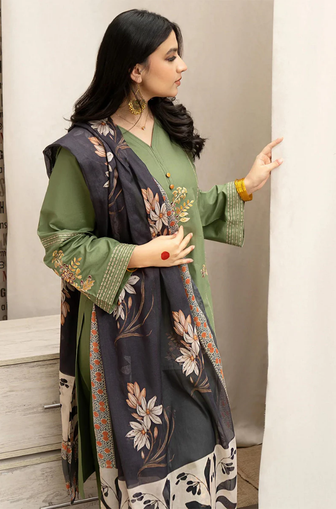 A woman elegantly draped in a green and black shawl, showcasing a blend of colors and textures.